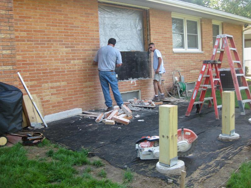 IMG_0808.JPG - July 6:  Custom Structures installed the new sliding door where there was only a window before.  The phone line has already been moved and the footings for the new deck dug and poured.