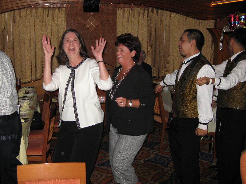 IMG_0183.JPG - Our tablemates dancing with the waiters at dinner.