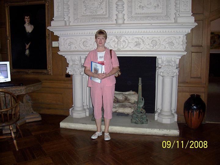 100_3967.JPG - Louann in front of a fireplace at the library & museum.